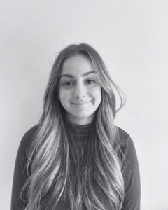 Diana Gancheva, Event Coordinator at Feast and Flow, smiling in a long-sleeved blouse against a plain background.